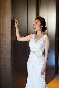 Bride leaning on wall